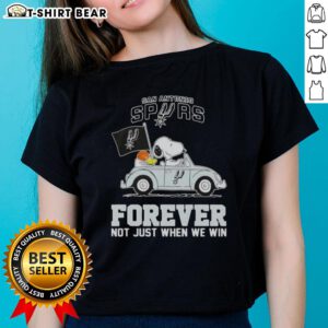 Alt Text: Snoopy driving a car in a San Antonio Spurs tee, celebrating team spirit with 'Forever, Not Just When We Win' slogan.