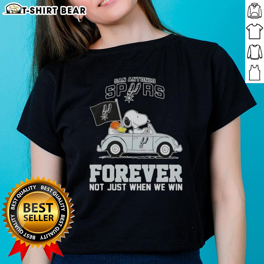 Alt Text: Snoopy driving a car in a San Antonio Spurs tee, celebrating team spirit with 'Forever, Not Just When We Win' slogan.