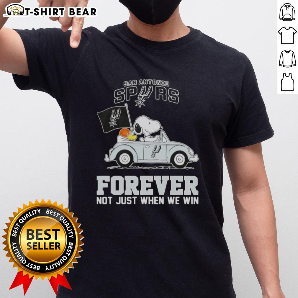 Snoopy driving a car on a San Antonio Spurs Forever T-shirt, celebrating team spirit beyond just winning.