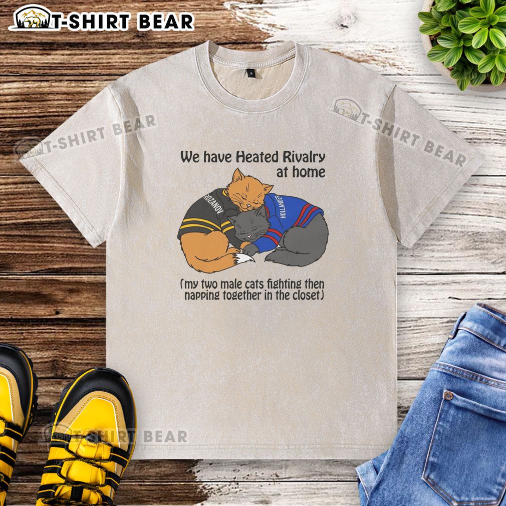 Two male cats playfully fighting and then napping together in a closet on a washed t-shirt, showcasing their heated rivalry.