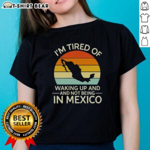 Retro ladies tee with 'I'm Tired of Waking Up and Not Being in Mexico' graphic, featuring a sunset design.