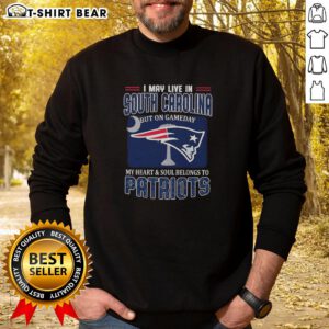 Alt Text: Cozy sweatshirt featuring 'I May Live In South Carolina, But On Gameday My Heart Belongs To New England Patriots' design.