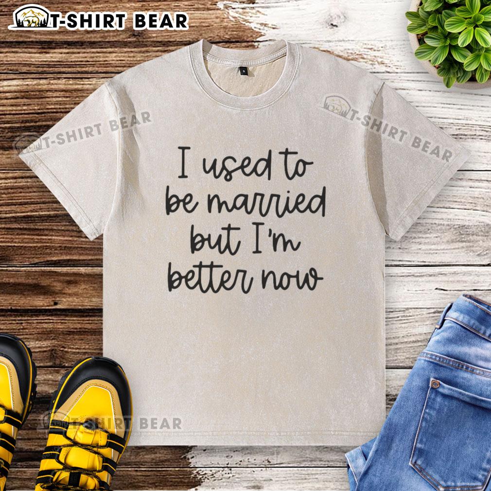 Original 'I Used to Be Married But I'm Better Now' washed t-shirt displayed on a wooden background, showcasing its design.