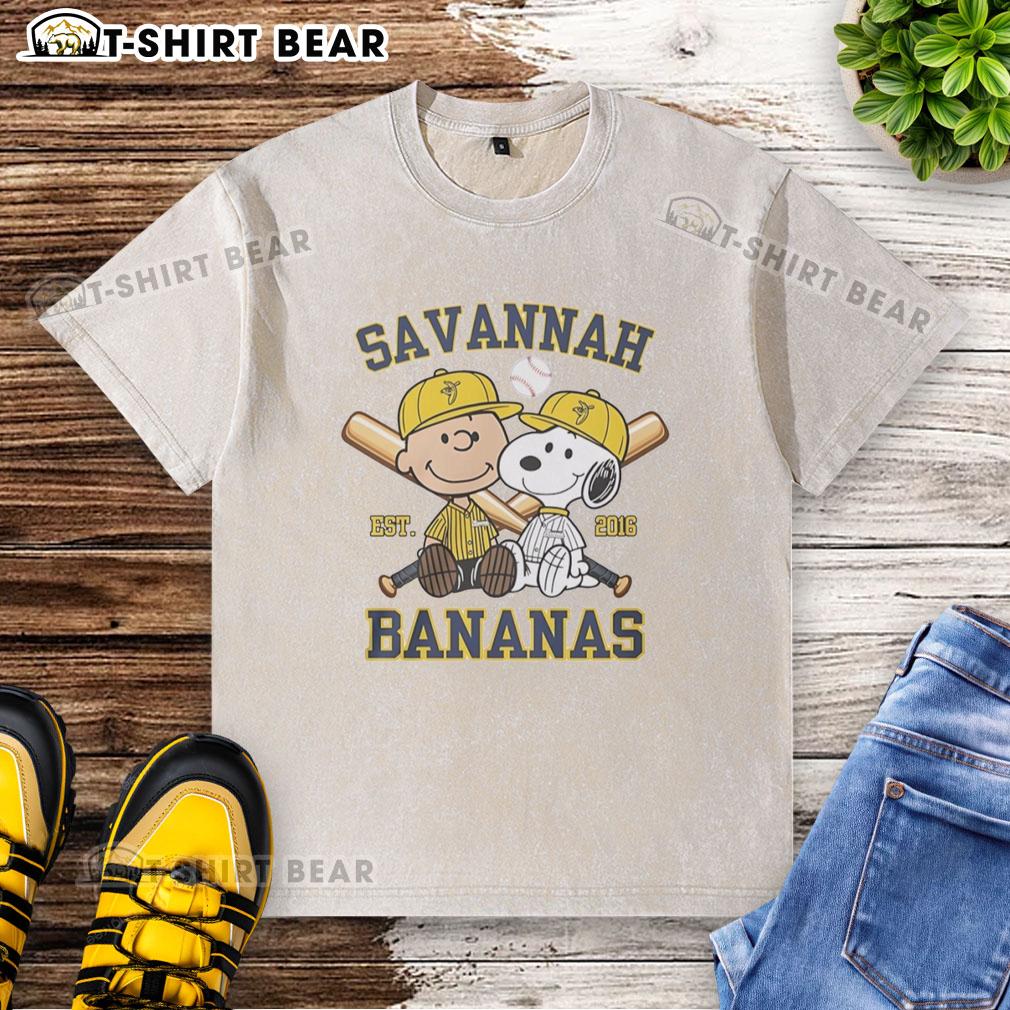 Alt Text: Charlie Brown and Snoopy in Savannah Bananas outfit on a washed t-shirt, celebrating Est. 2016 style.