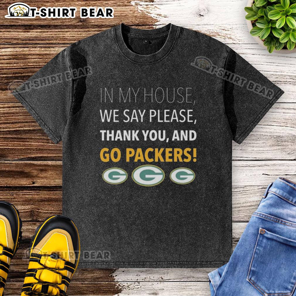 Top In My House We Say Please Thank You And Go Packers washed t-shirt displayed on a hanger, featuring a vibrant design.