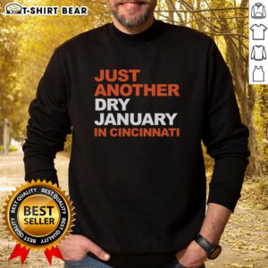 Cozy 'Just Another Dry January in Cincinnati' sweatshirt displayed on a wooden table, perfect for winter style.
