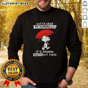 Cozy sweatshirt featuring Snoopy with the phrase 'Gotta Grab My Dumbrella, It's Raining Idiots Out There' perfect for Peanuts fans.