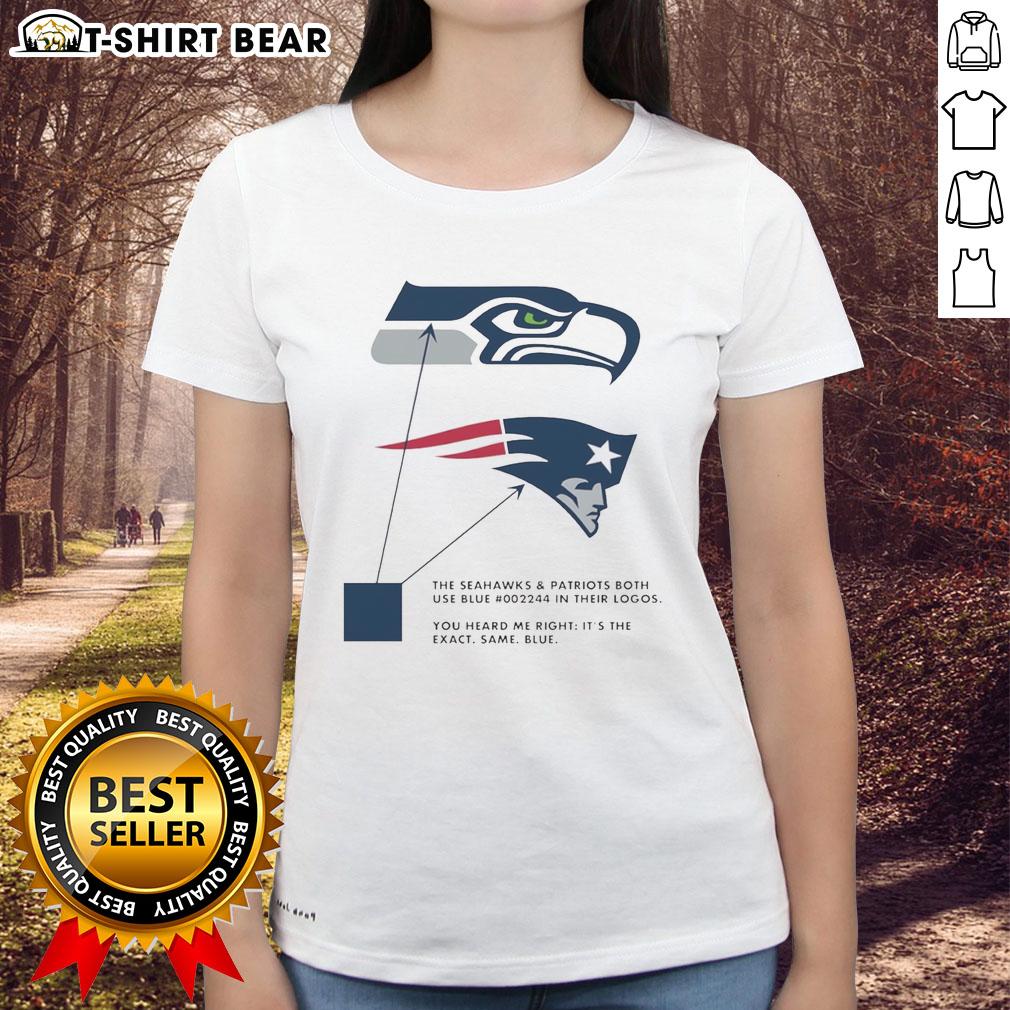 Seattle Seahawks and New England Patriots logos in blue on a ladies tee, showcasing team spirit and style.