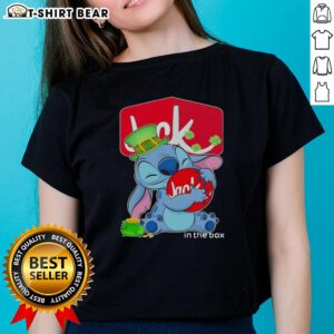 Happy St. Patrick's Day ladies tee featuring the Pretty Stitch Hug Jack-in-the-Box logo in vibrant green design.