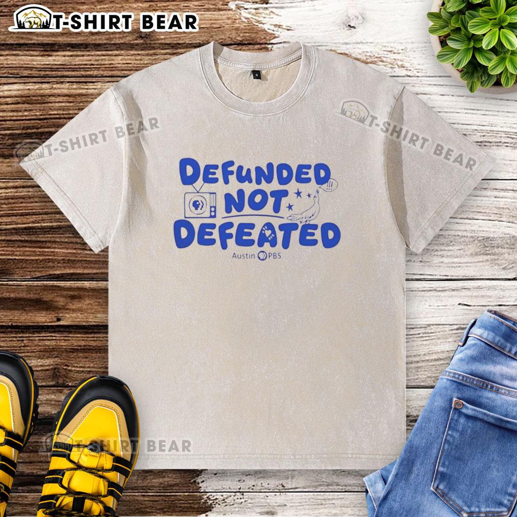 Good Defunded Not Defeated Austin PBS slogan on a washed t-shirt, promoting local public broadcasting support.