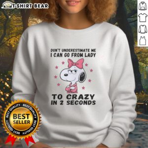 Snoopy sweatshirt with 'Don't Underestimate Me' quote, showcasing playful design and vibrant colors.