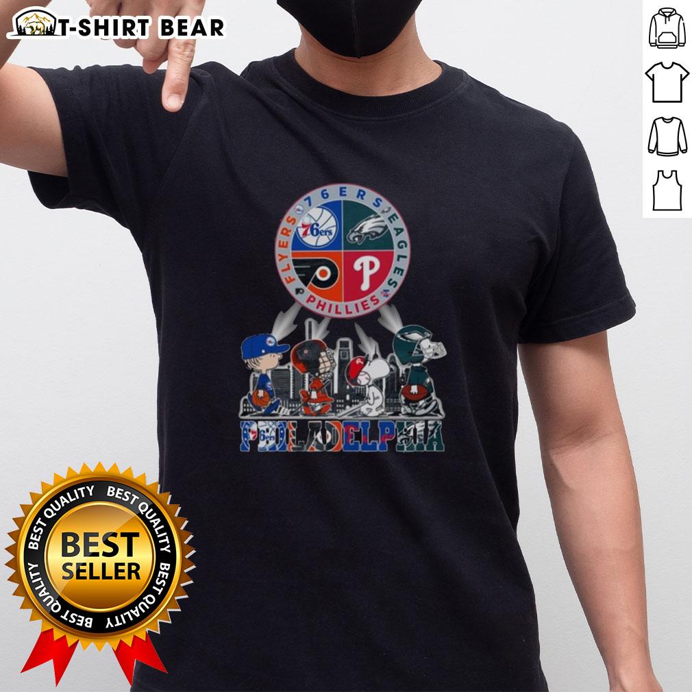 Alt Text: Original Philadelphia Sports Teams Snoopy T-shirt featuring 76ers, Eagles, Flyers, and Phillies logo designs.