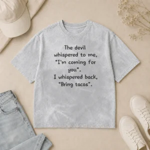 Good The Devil Whispered To Me I'M Coming For You I Whispered Back Bring Tacos printed on a soft washed t shirt in light gray