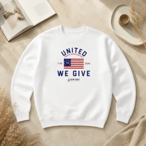 Original United 250th Anniversary 1776 2026 We Give Kentucky Blood Center sweater in dark color with bold anniversary design