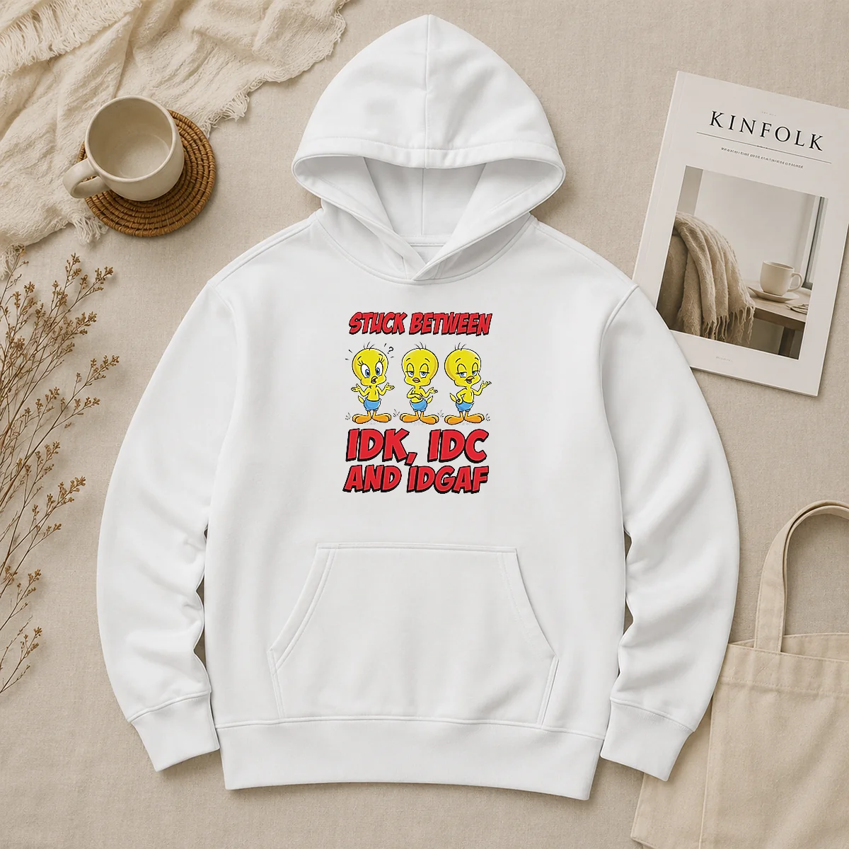 Pretty Tweety Stuck Between IDK IDC And IDGAF Hoodie Pretty Tweety Stuck Between IDK IDC And IDGAF Hoodie in black, front view with kangaroo pocket and drawstring hood