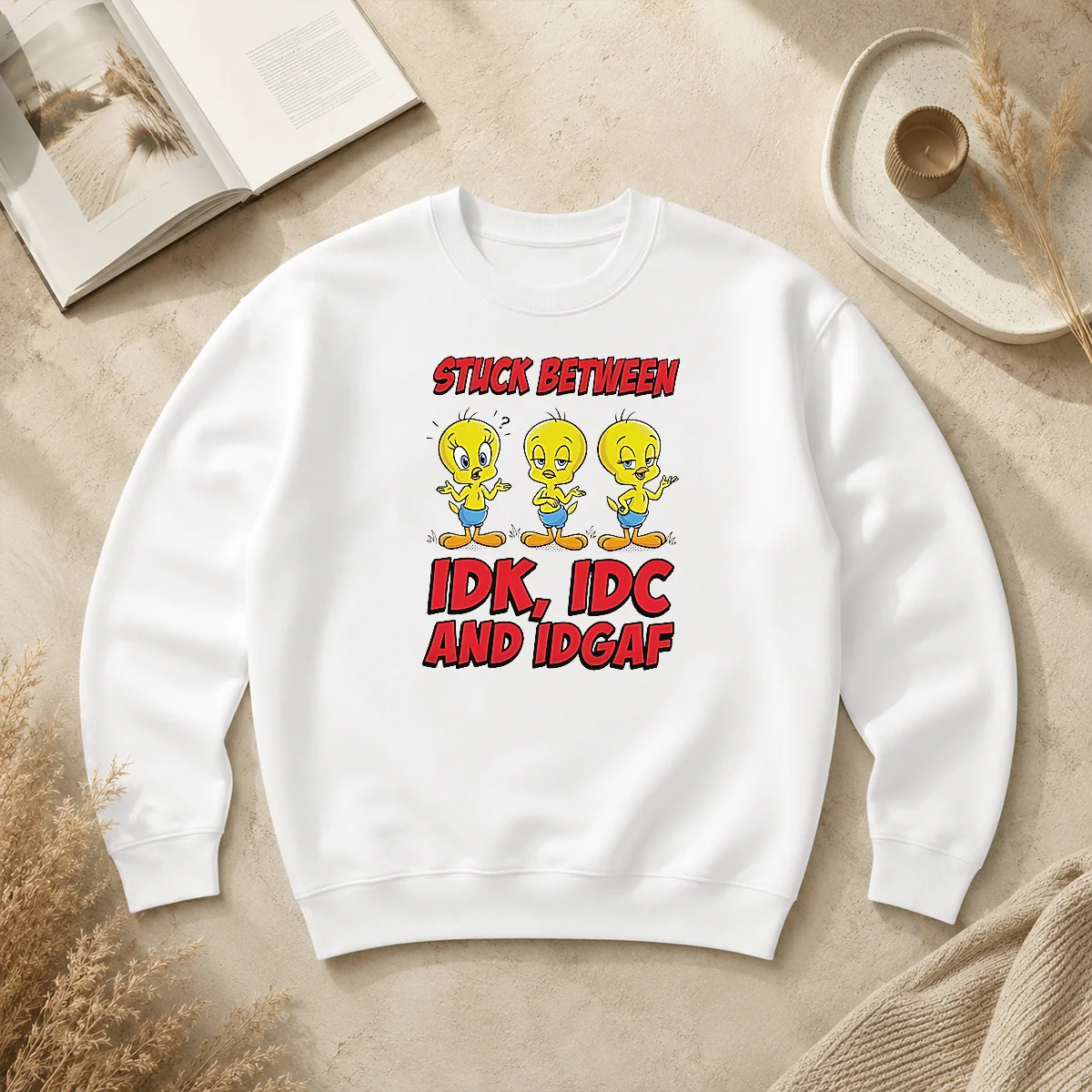 Pretty Tweety Stuck Between IDK IDC And IDGAF Sweater Pretty Tweety Stuck Between IDK IDC And IDGAF Sweater in a cozy crewneck style with bold graphic print